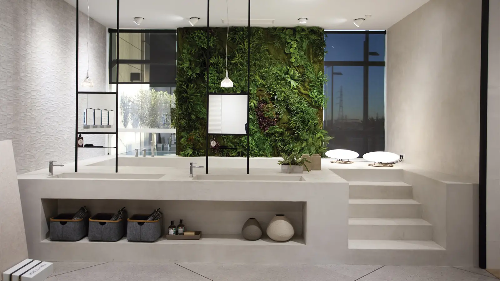 Wide basin area and light-coloured steps against a planted wall
