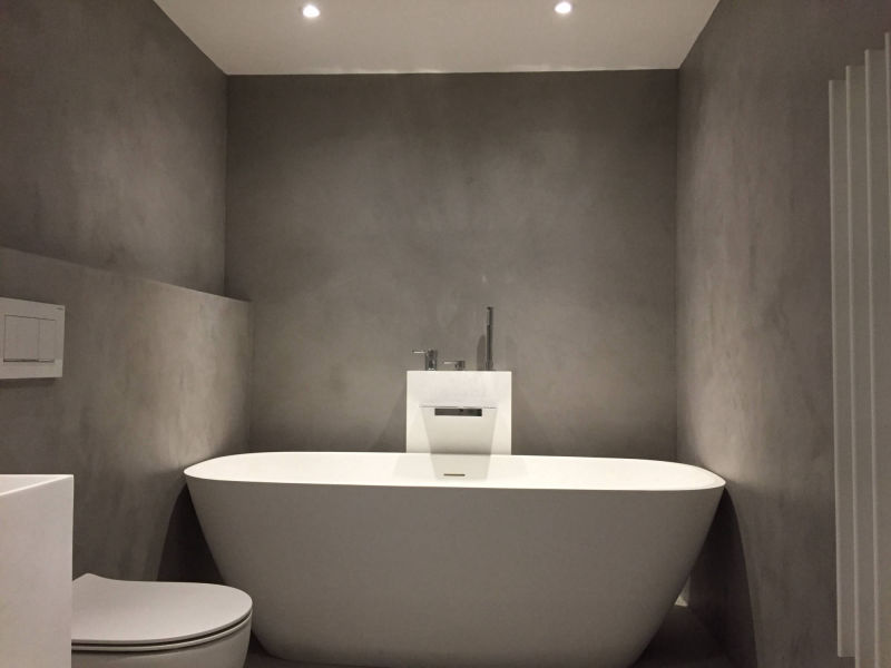 Freestanding white bath against grey walls