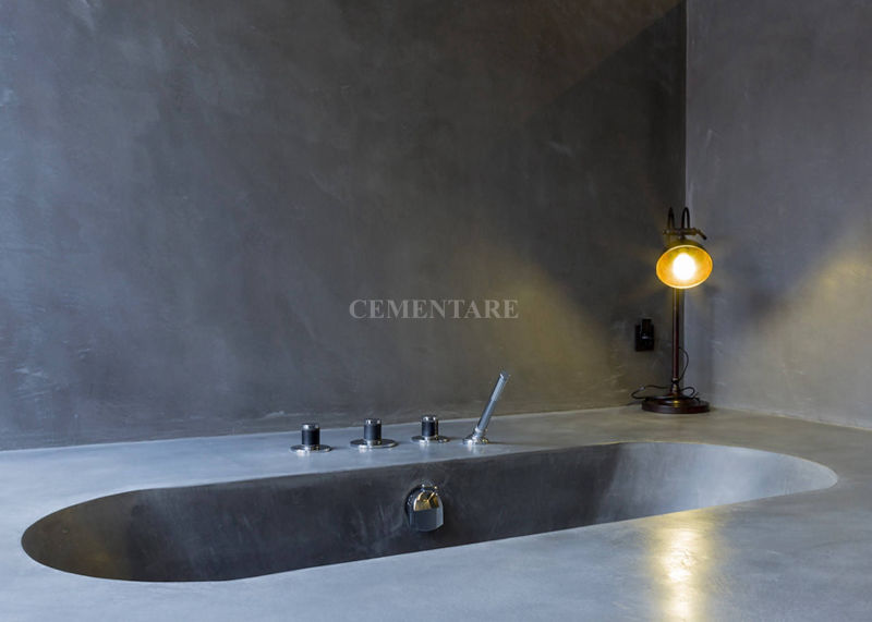 Oval bath and bathroom walls blending with grey surfaces