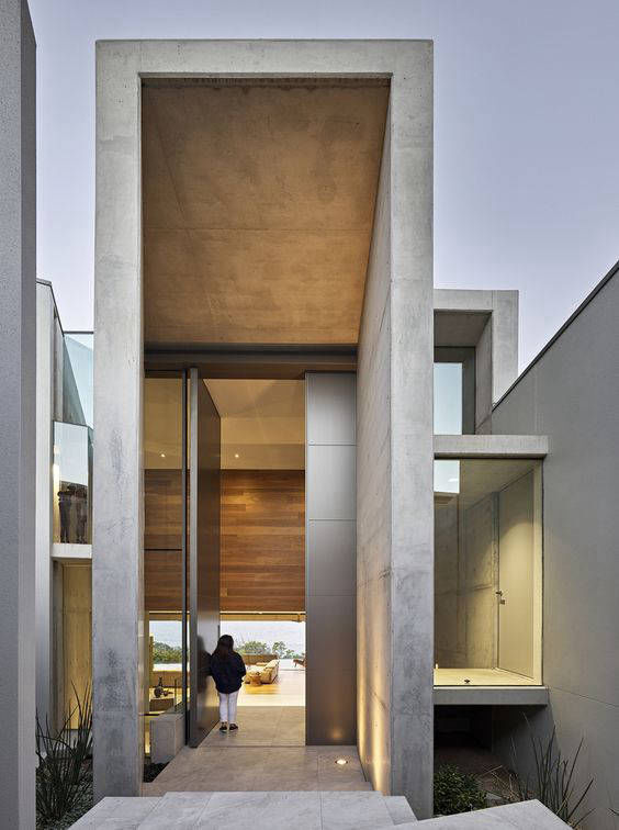 Grey façade surround framing a tall glazed entrance