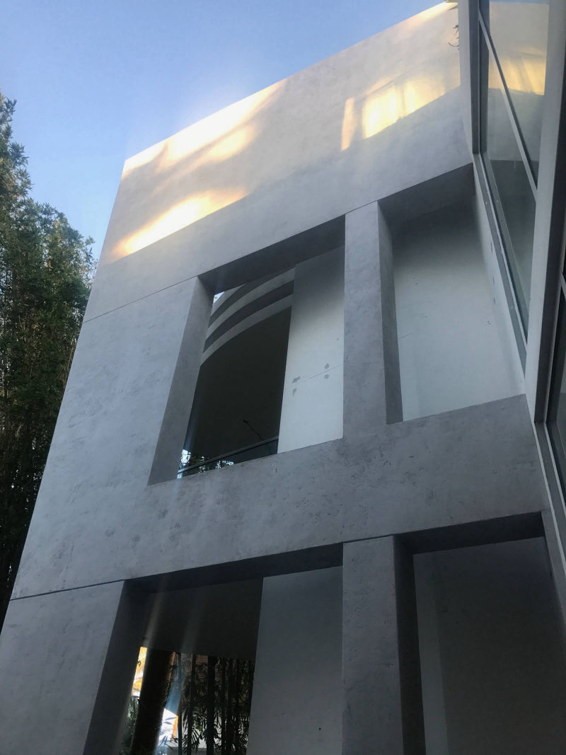 Multi-storey grey façade with rectangular window openings