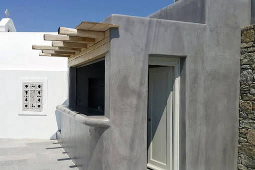 Grey exterior façade and bar worktop with a timber pergola