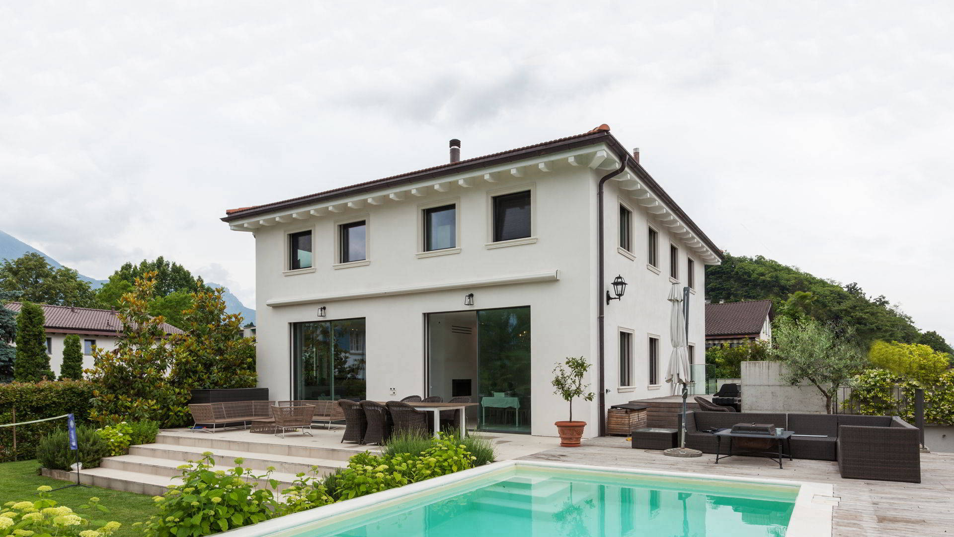 Cementare pool and terrace within natural landscaping