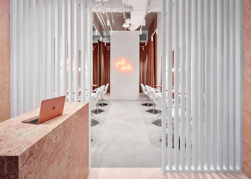 Light-coloured retail passage between white vertical partitions