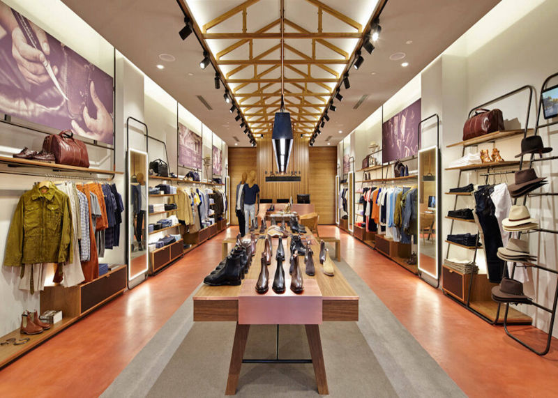 Orange and grey floor bands in a clothing shop with a timber roof