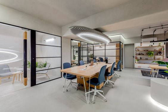 Bright meeting area with a timber table and blue chairs