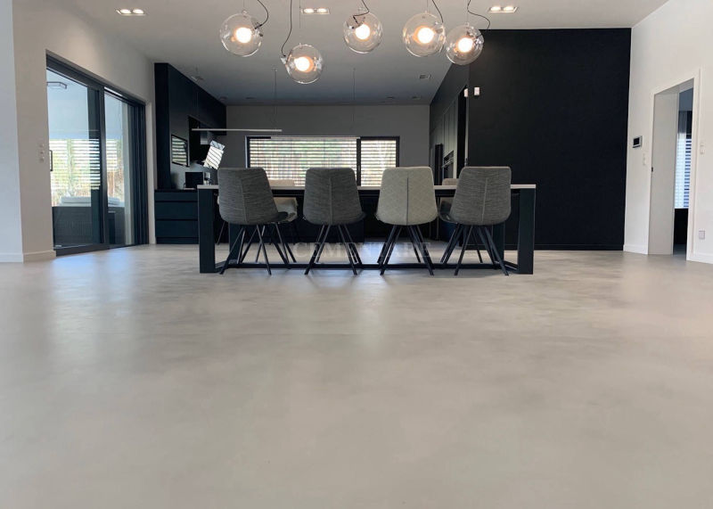 Light grey flooring around a meeting table against a dark wall
