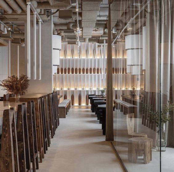 Light-coloured flooring between glass partitions and bar stools