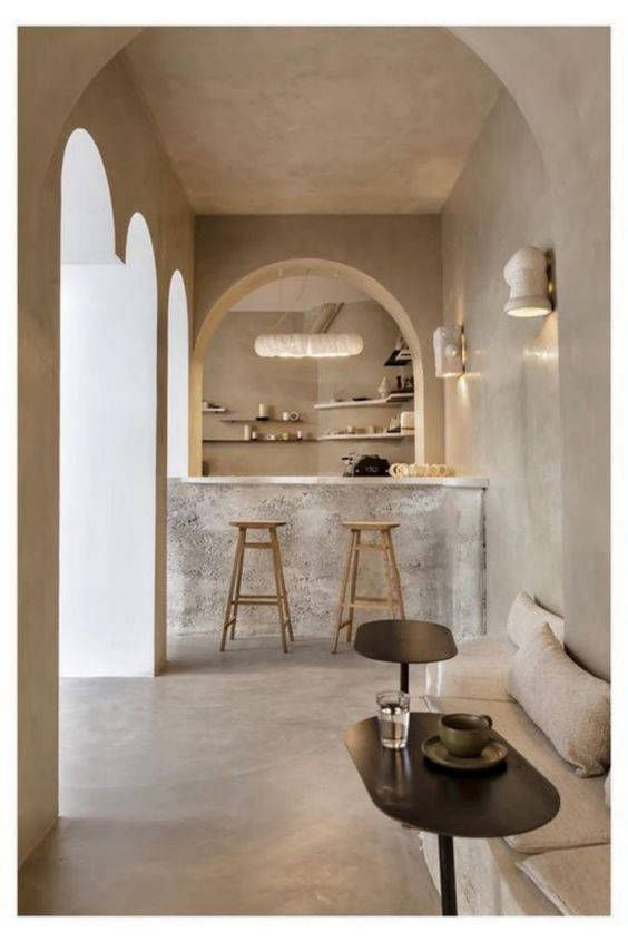 Light-toned interior with arched niches and a bar counter
