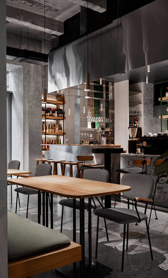 Grey column surface beside a round table and open shelves