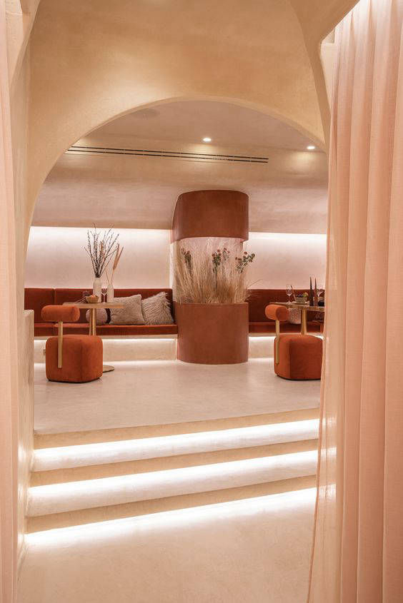 Illuminated entrance steps in a warm-toned arched restaurant